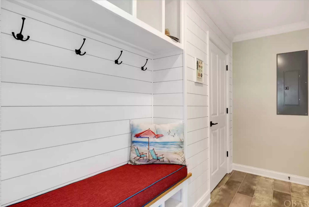 Design ideas for a small beach style boot room in Other with light hardwood flooring, beige floors and tongue and groove walls.