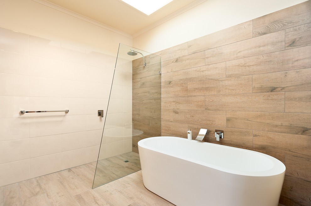 Modern bathroom in Melbourne with a freestanding tub and a curbless shower.