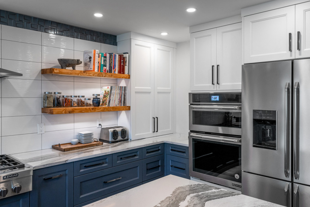 Large transitional u-shaped dark wood floor and brown floor eat-in kitchen photo with an undermount sink, recessed-panel cabinets, blue cabinets, quartz countertops, white backsplash, ceramic backsplash, stainless steel appliances, an island and white countertops