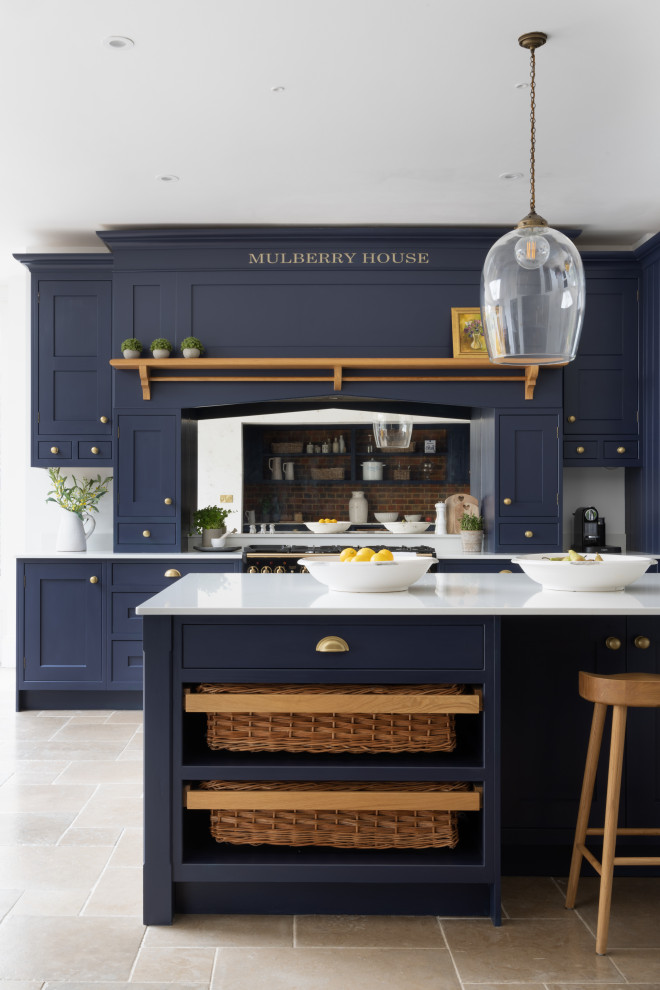 Design ideas for a large traditional kitchen in Hampshire with shaker cabinets, blue cabinets, quartz benchtops, metallic splashback, with island and white benchtop.