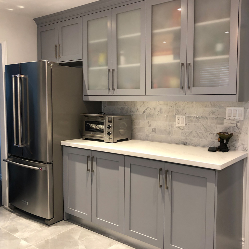 Mid-sized contemporary galley eat-in kitchen in Toronto with an undermount sink, grey cabinets, marble benchtops, grey splashback, marble splashback, stainless steel appliances, ceramic floors, grey floor and white benchtop.