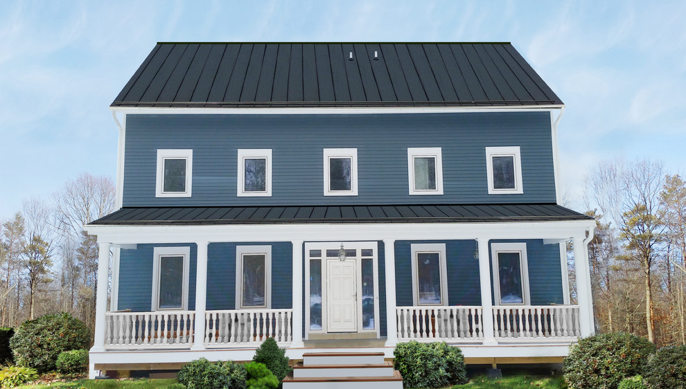 Mid-sized country two-storey blue house exterior in New York with mixed siding, a gable roof and a metal roof.