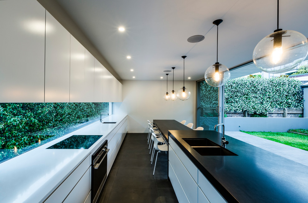 Inspiration for a contemporary kitchen in Sydney with an undermount sink, flat-panel cabinets, white cabinets, wood benchtops and with island.