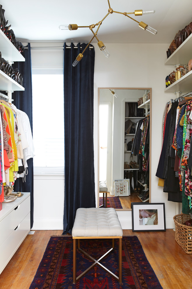 Dressing room - transitional gender-neutral medium tone wood floor and brown floor dressing room idea in Toronto with open cabinets and white cabinets
