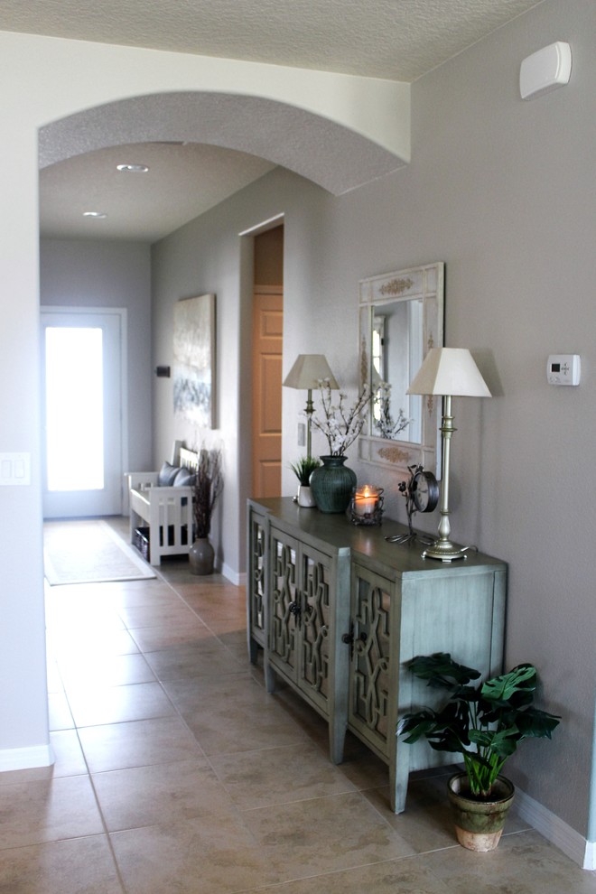 Design ideas for a mid-sized beach style foyer in New Orleans with a single front door, green walls and porcelain floors.