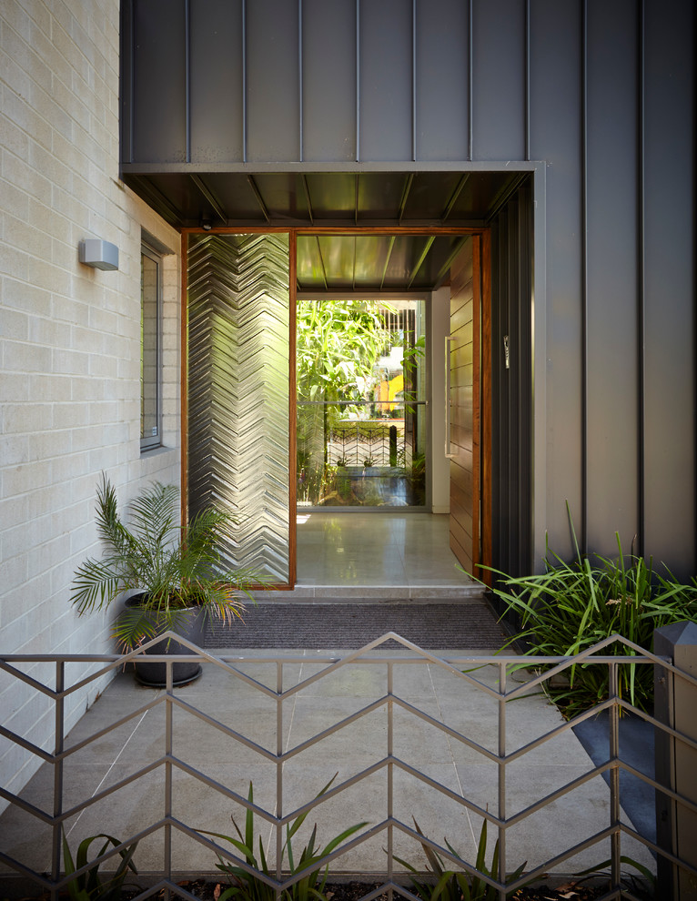Contemporary front door in Melbourne with a single front door and a medium wood front door.