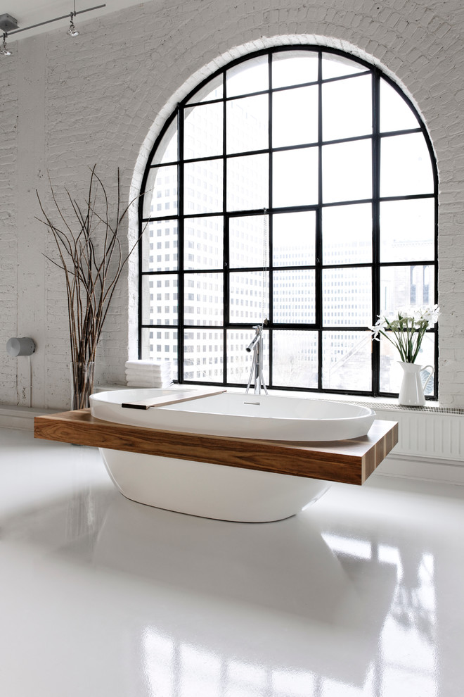 Inspiration for a large contemporary master bathroom in Cleveland with a freestanding tub, white walls and marble floors.