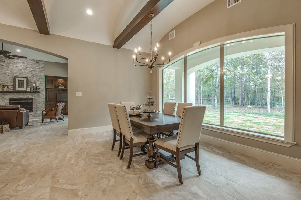 This is an example of a large mediterranean kitchen/dining combo in Houston with beige walls, ceramic floors, no fireplace and beige floor.