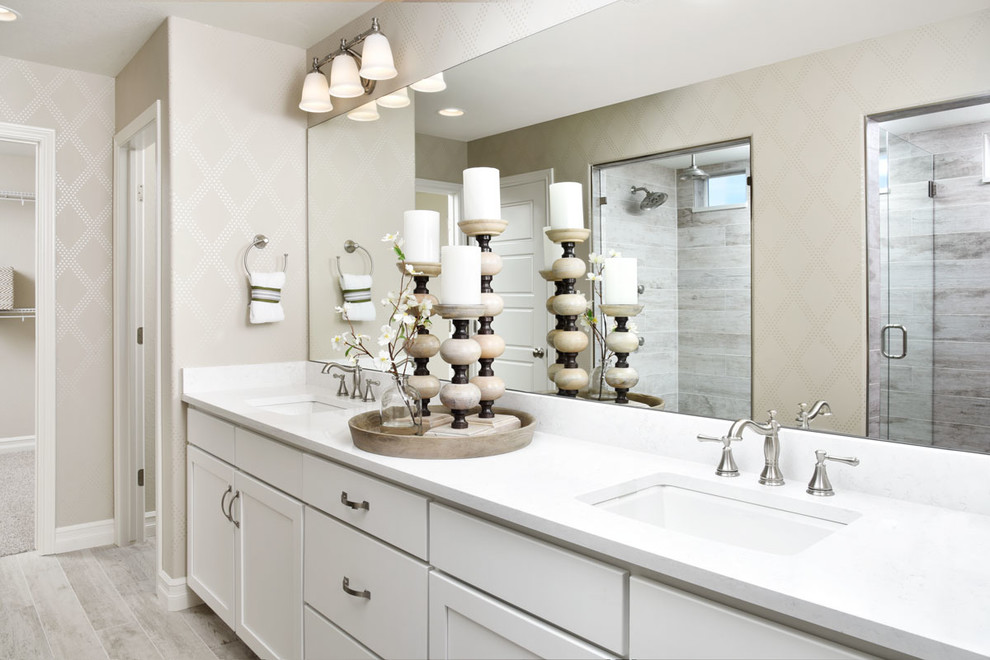 This is an example of a contemporary master bathroom in Denver with white cabinets and white benchtops.