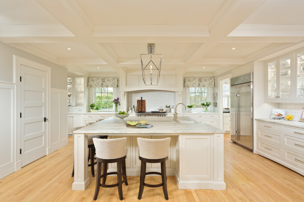 Inspiration for a transitional light wood floor kitchen remodel in Boston with white backsplash, cement tile backsplash and white countertops