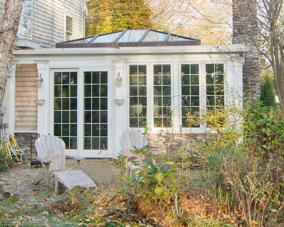 Inspiration for a mid-sized traditional sunroom in Boston with medium hardwood floors, a standard fireplace, a brick fireplace surround and a skylight.