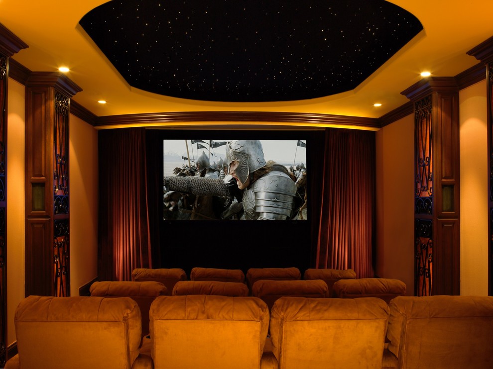 This is an example of a traditional home theatre in Los Angeles with a projector screen.