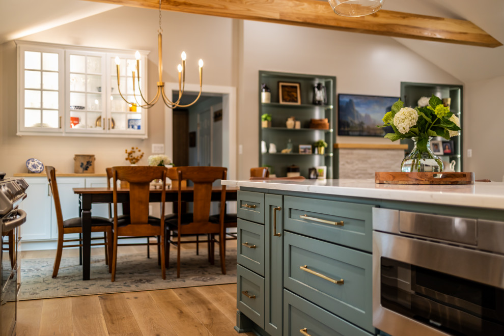 Example of a large transitional l-shaped light wood floor, brown floor and exposed beam eat-in kitchen design in DC Metro with an undermount sink, shaker cabinets, quartz countertops, white backsplash, porcelain backsplash, stainless steel appliances, an island and white countertops