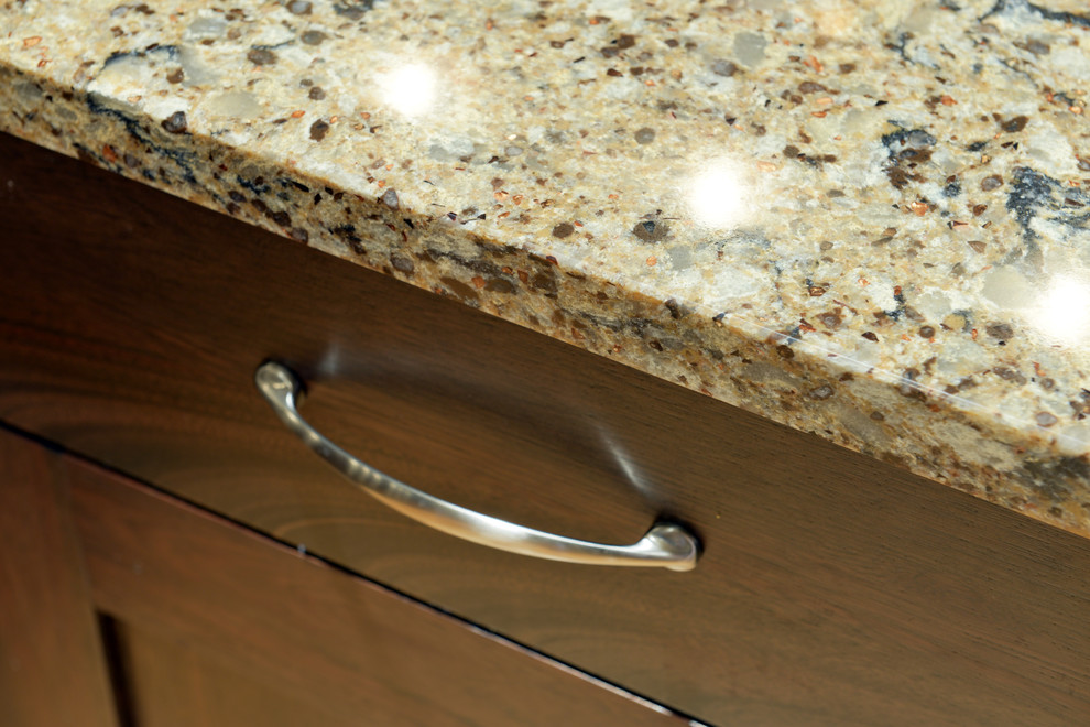 Example of a mid-sized transitional l-shaped light wood floor open concept kitchen design with an undermount sink, shaker cabinets, dark wood cabinets, quartzite countertops, multicolored backsplash, mosaic tile backsplash, stainless steel appliances and an island