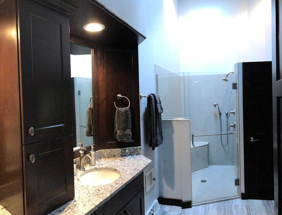 Mid-sized transitional master gray tile gray floor bathroom photo in Milwaukee with shaker cabinets, dark wood cabinets, a two-piece toilet, gray walls, an undermount sink and quartz countertops