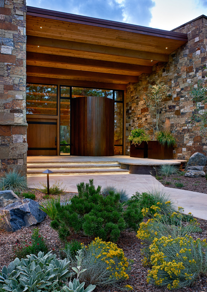 Inspiration for a large rustic single front door remodel in Denver with a medium wood front door