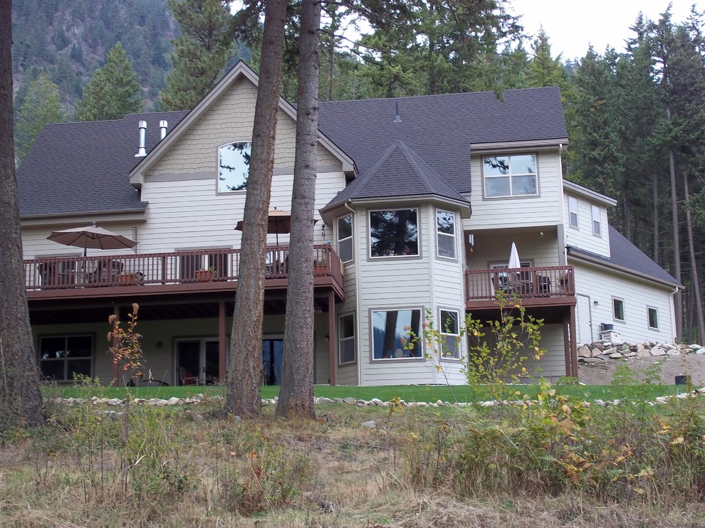 Inspiration for a large rustic backyard ground level privacy and wood railing deck remodel with no cover