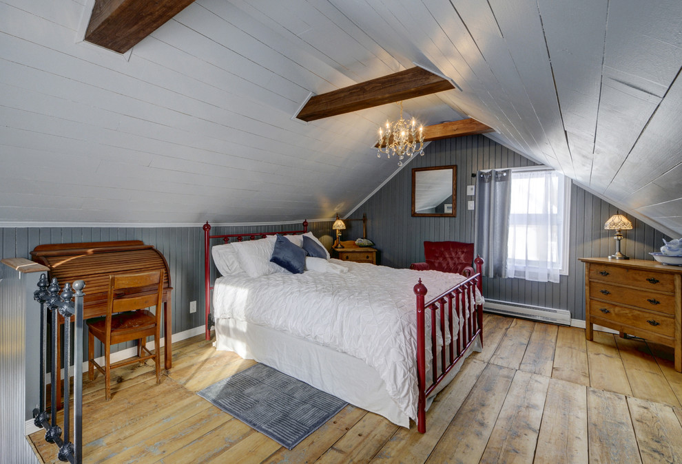 Photo of a large country master bedroom in Other with grey walls and light hardwood floors.