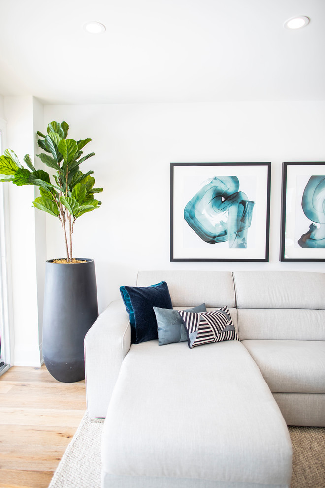 Mid-sized contemporary open concept family room in Toronto with white walls, medium hardwood floors, a ribbon fireplace, a stone fireplace surround, a wall-mounted tv and brown floor.