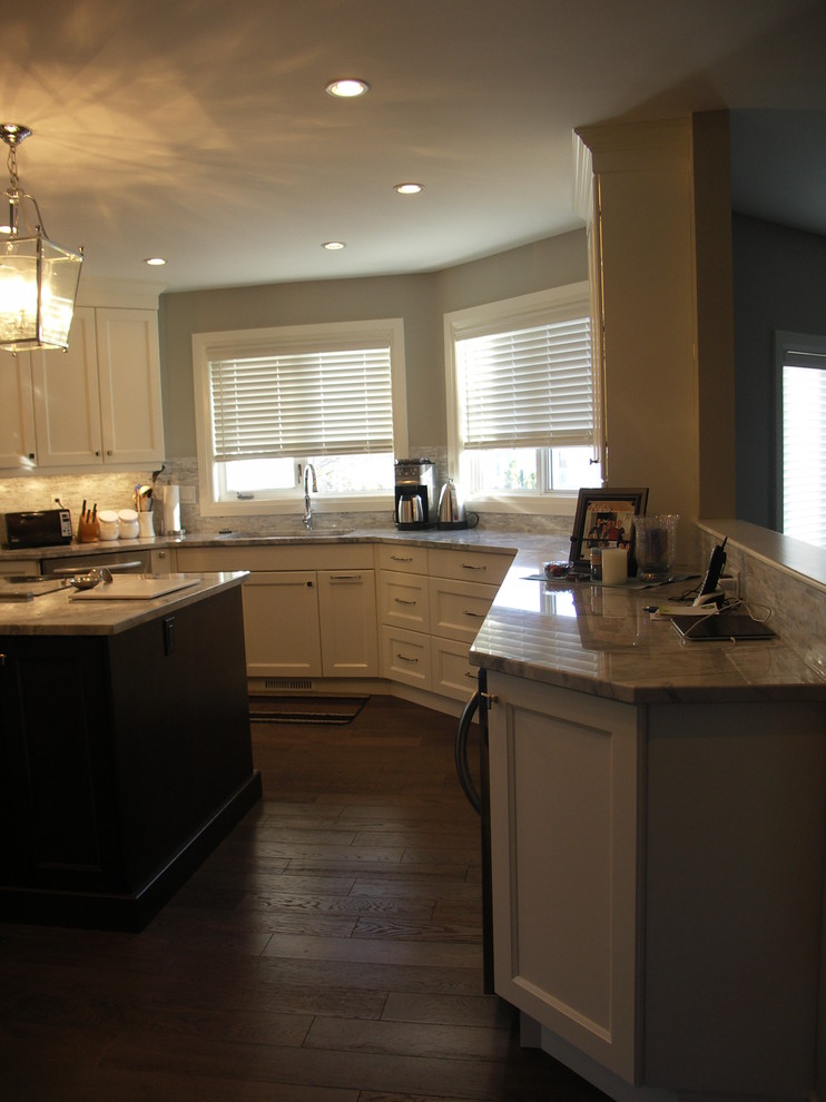 Eat-in kitchen - mid-sized transitional u-shaped medium tone wood floor and brown floor eat-in kitchen idea in Edmonton with recessed-panel cabinets, white cabinets, an undermount sink, stainless steel appliances, an island, marble countertops, gray backsplash and matchstick tile backsplash