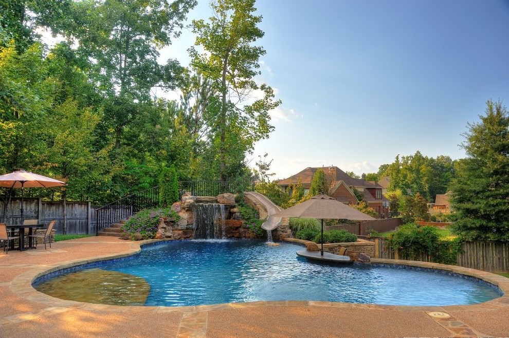 Design ideas for a traditional custom-shaped pool in Other with a water slide.