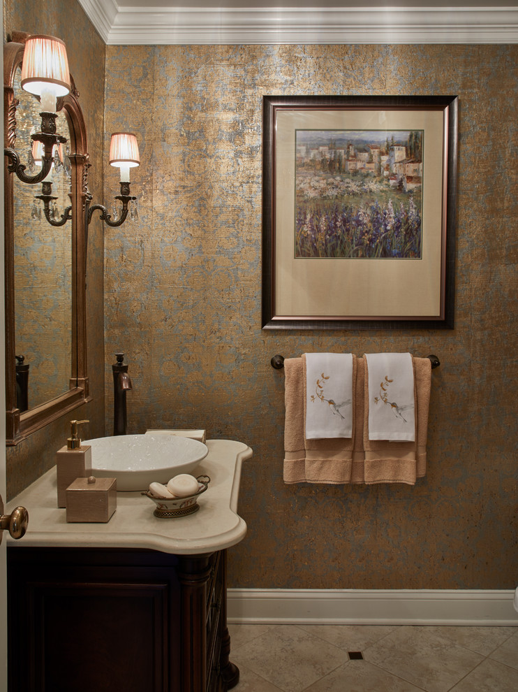 Design ideas for a mid-sized traditional powder room in New York with furniture-like cabinets, brown cabinets, a one-piece toilet, beige tile, yellow walls, marble floors, a vessel sink, marble benchtops and beige floor.