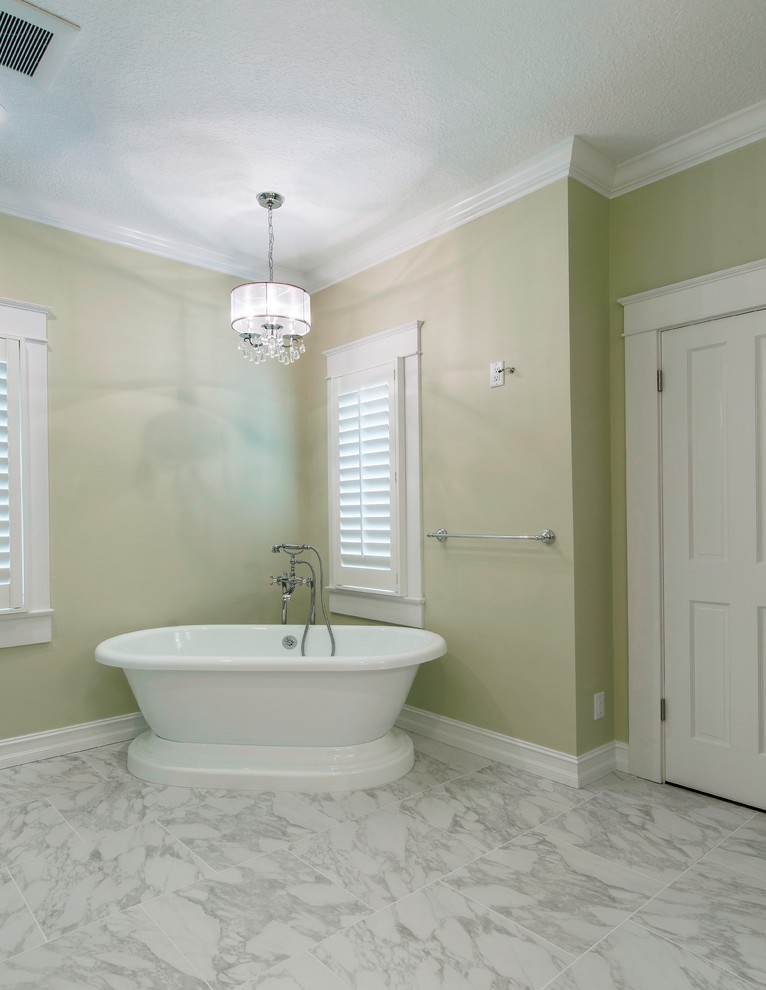 Traditional master bathroom in Tampa with an undermount sink, raised-panel cabinets, white cabinets, engineered quartz benchtops, a freestanding tub, a corner shower, a wall-mount toilet, gray tile, porcelain tile, green walls and porcelain floors.