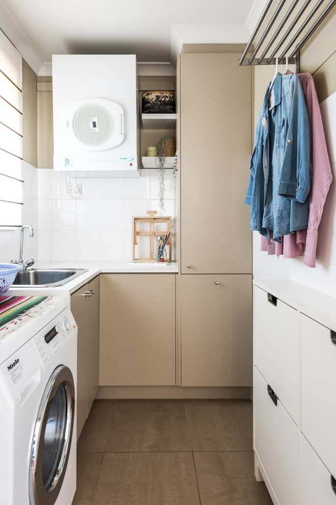 Inspiration for a small eclectic l-shaped dedicated laundry room in Melbourne with a single-bowl sink, flat-panel cabinets, beige cabinets, laminate benchtops, beige walls, porcelain floors, beige floor and white benchtop.