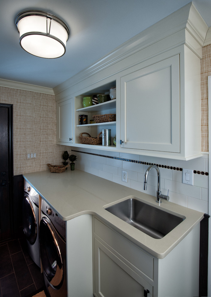 Inspiration for a mid-sized traditional single-wall dedicated laundry room in Philadelphia with an undermount sink, shaker cabinets, white cabinets, solid surface benchtops, dark hardwood floors, a side-by-side washer and dryer and brown walls.