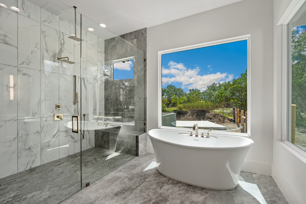 Inspiration for a large transitional master gray tile double-sink freestanding bathtub remodel with a hinged shower door