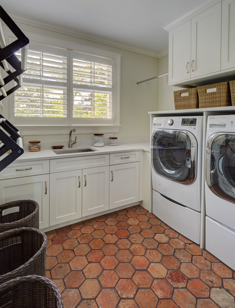 Inspiration for a small timeless u-shaped terra-cotta tile and multicolored floor utility room remodel in Chicago with an undermount sink, open cabinets, white cabinets, solid surface countertops, white walls, a side-by-side washer/dryer and white countertops