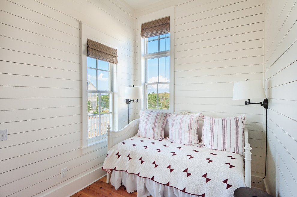 This is an example of a beach style bedroom in Miami with white walls.