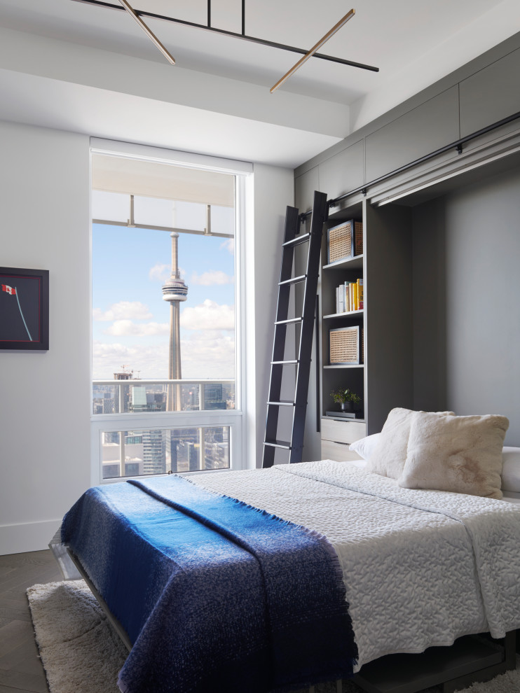 Inspiration for a mid-sized contemporary guest bedroom in Toronto with white walls, medium hardwood floors and brown floor.