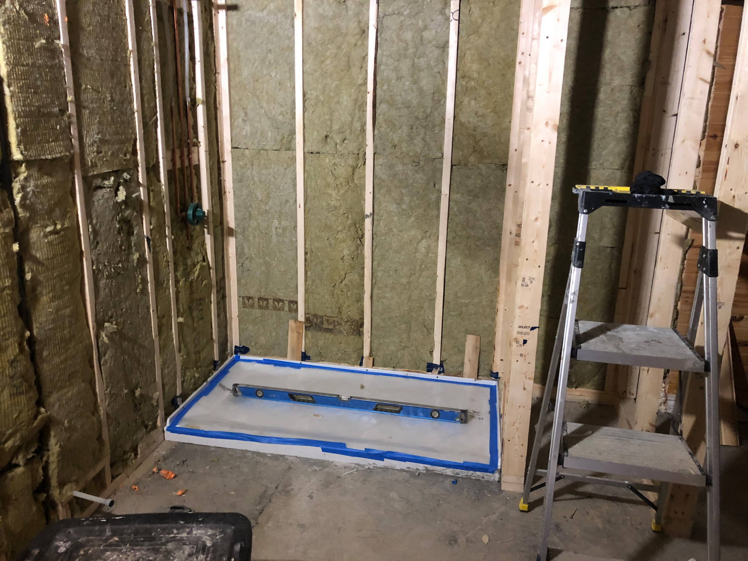Tile install process including under tile waterproofing