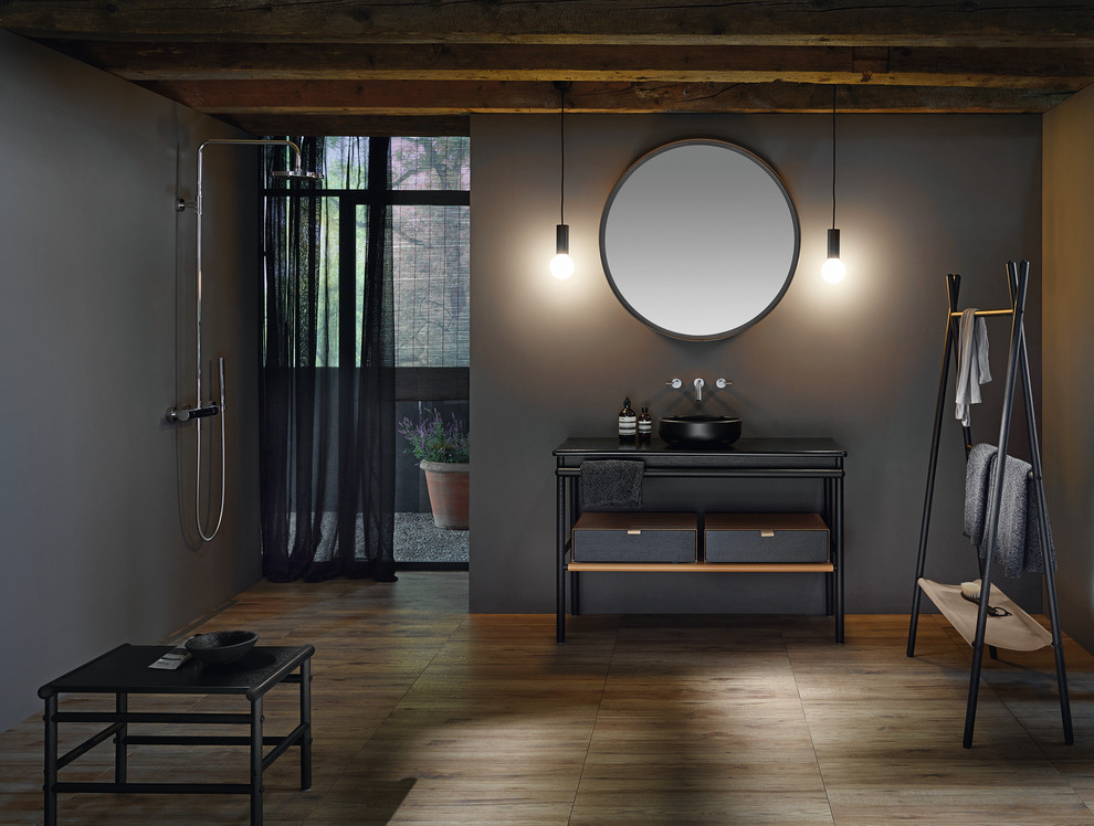 Photo of a large modern bathroom in Nuremberg with open cabinets, dark wood cabinets and a vessel sink.