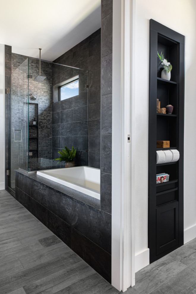 Photo of a modern master bathroom in Austin with shaker cabinets, black cabinets, a drop-in tub, white walls, a hinged shower door, black benchtops, an enclosed toilet, a double vanity and a built-in vanity.