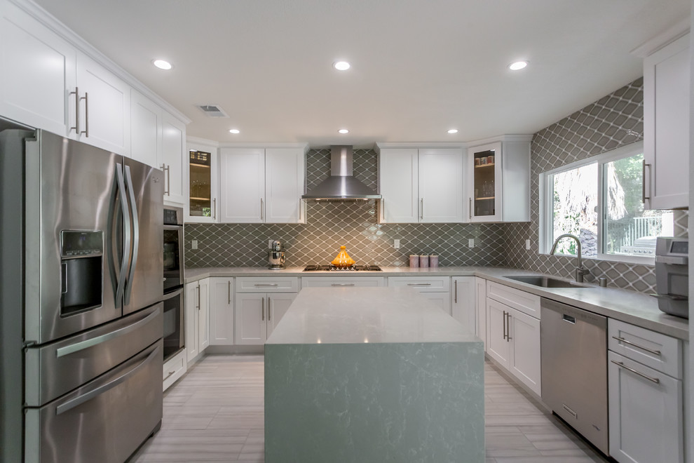 Open concept kitchen - large transitional u-shaped porcelain tile open concept kitchen idea in Los Angeles with shaker cabinets, white cabinets, an island, a single-bowl sink, quartzite countertops, gray backsplash, porcelain backsplash and stainless steel appliances