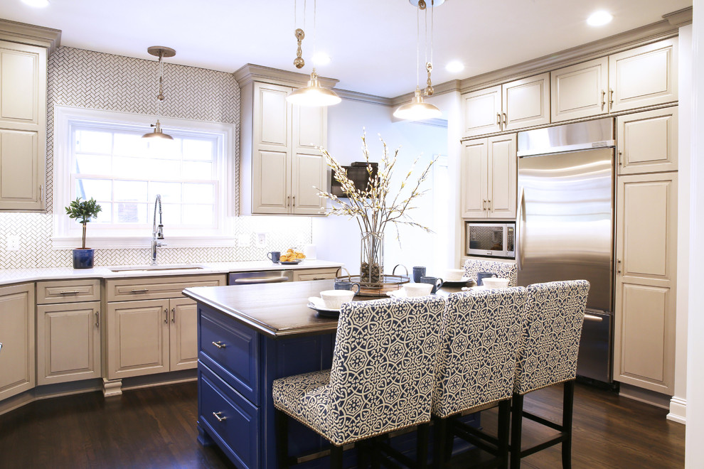 Enclosed kitchen - large transitional l-shaped dark wood floor and brown floor enclosed kitchen idea with raised-panel cabinets, white backsplash, ceramic backsplash, stainless steel appliances and an island