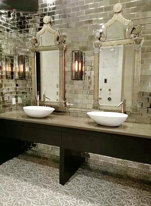 Photo of a large eclectic master bathroom in Tampa with a vessel sink, flat-panel cabinets, dark wood cabinets, solid surface benchtops, a double shower, gray tile, mirror tile, grey walls and marble floors.