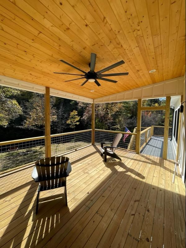 Idéer för att renovera en stor lantlig innätad veranda på baksidan av huset, med trädäck, takförlängning och räcke i flera material