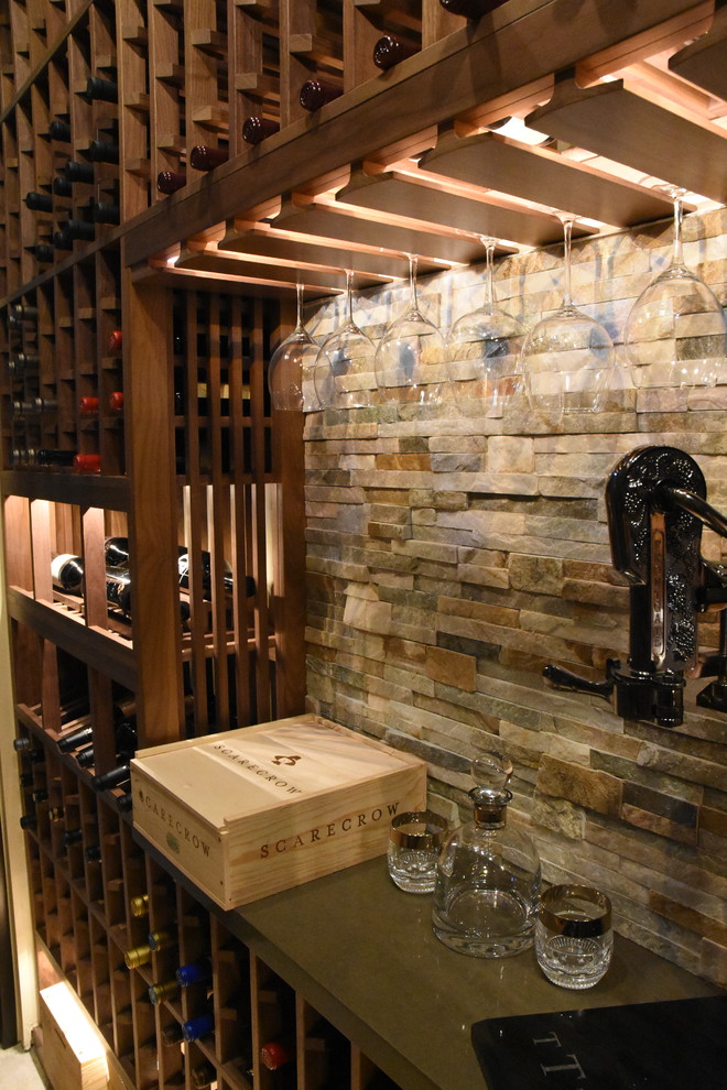 This is an example of a mid-sized traditional wine cellar in Los Angeles with terra-cotta floors and display racks.