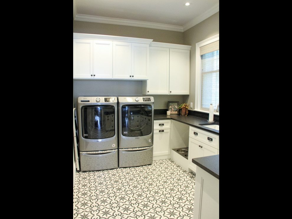 Example of a transitional u-shaped dedicated laundry room design with an undermount sink, recessed-panel cabinets, white cabinets and a side-by-side washer/dryer