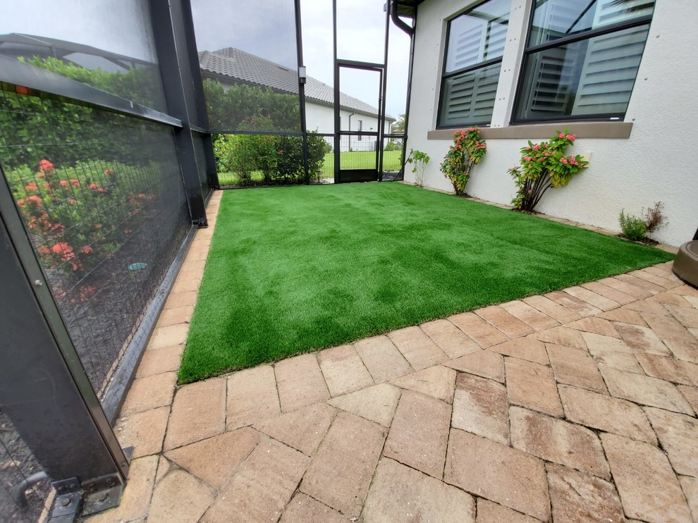 Inspiration for a small timeless backyard brick patio remodel in Miami with no cover