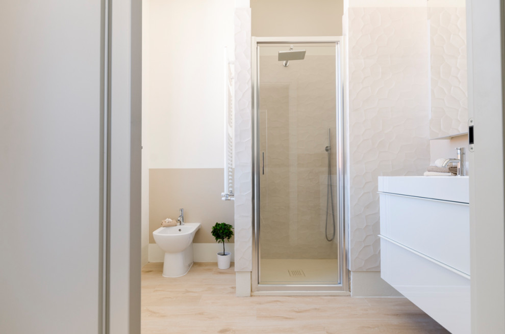 Design ideas for a small modern bathroom in Milan with flat-panel cabinets, white cabinets, a two-piece toilet, multi-coloured tile, porcelain tile, beige walls, an integrated sink, engineered quartz benchtops, beige floor, white benchtops, a floating vanity and wood-look tile.