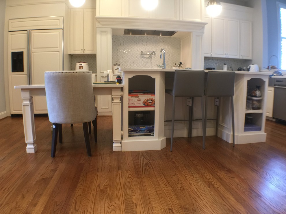 Inspiration for a large transitional u-shaped medium tone wood floor open concept kitchen remodel in DC Metro with an undermount sink, raised-panel cabinets, white cabinets, quartzite countertops, stainless steel appliances and an island