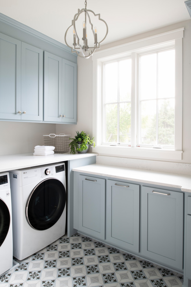 Inspiration for a traditional laundry room in Minneapolis with quartz benchtops and a side-by-side washer and dryer.