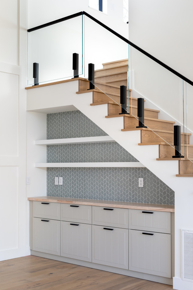 This is an example of a modern staircase in Other with glass railing.