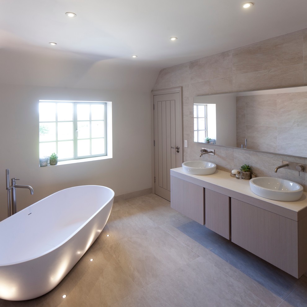 Large contemporary master bathroom in West Midlands with flat-panel cabinets, light wood cabinets, a freestanding tub, an open shower, beige tile, ceramic tile, white walls, ceramic floors, quartzite benchtops and a drop-in sink.
