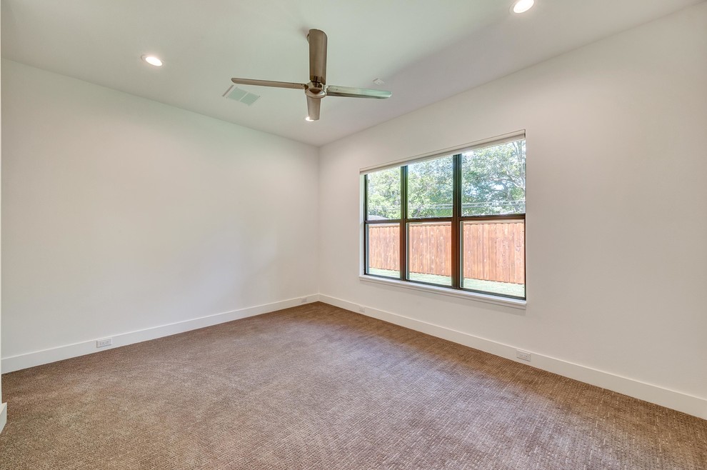 Example of a minimalist guest carpeted and gray floor bedroom design in Dallas with white walls