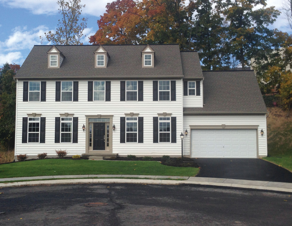 Mid-sized elegant two-story beige home design photo